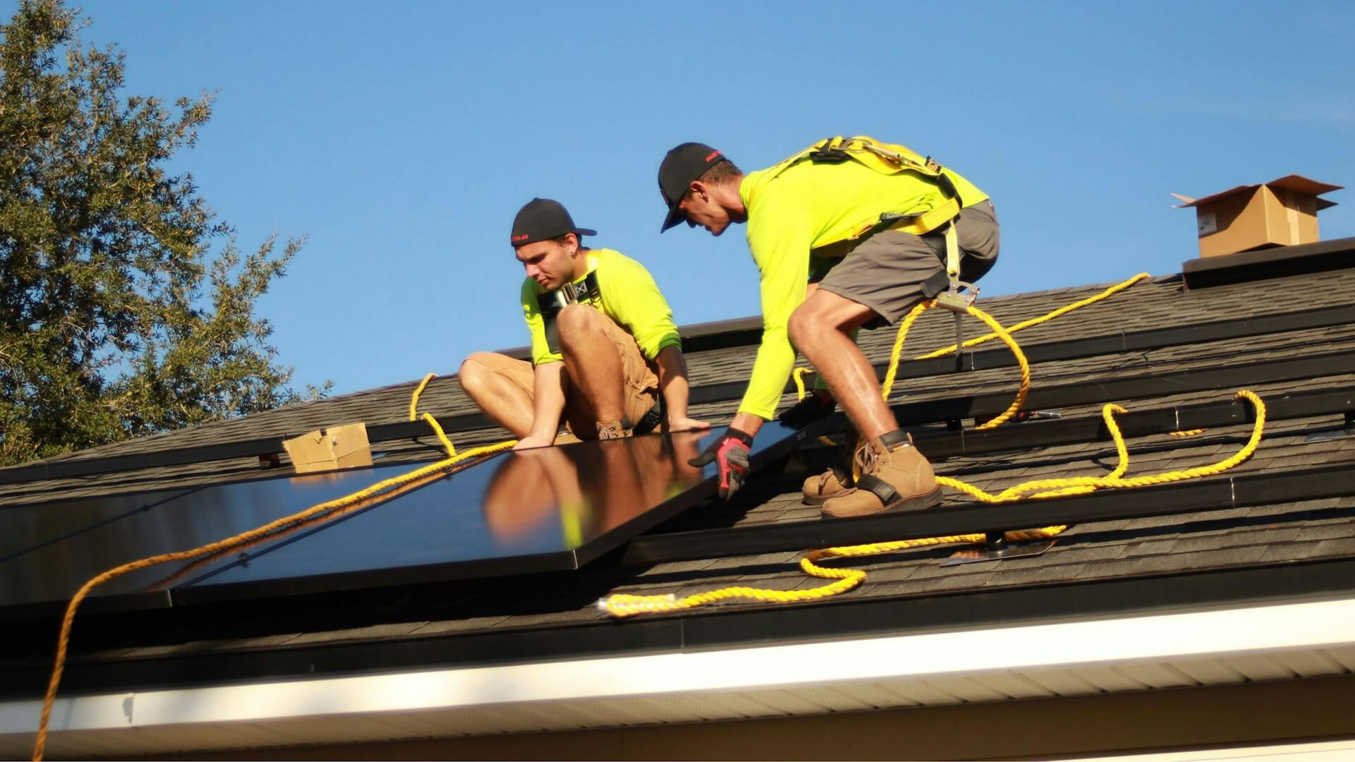Dos hombres en un techo instalando paneles solares